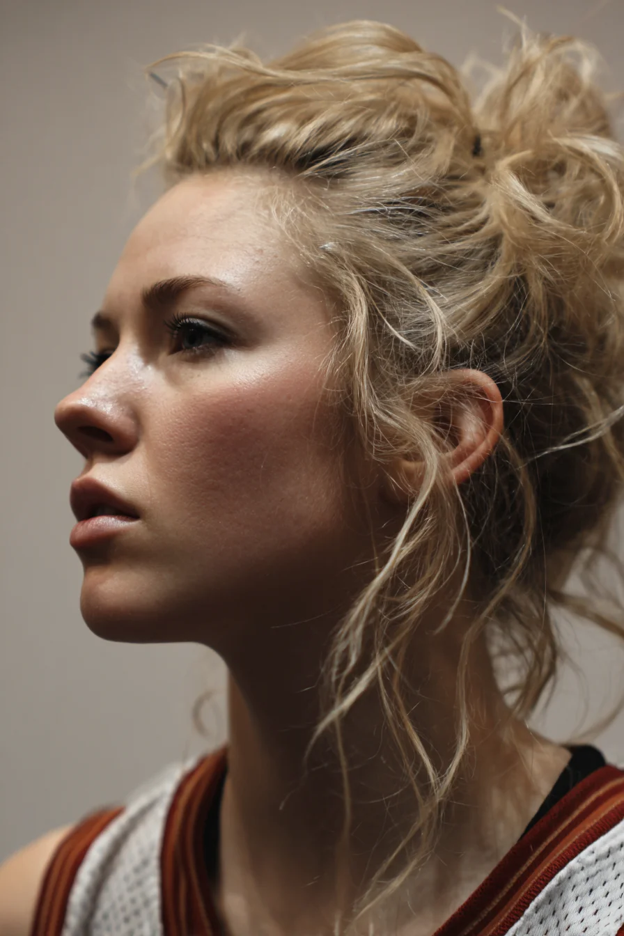 Textured Messy High Bun with Face‑Framing Tendrils